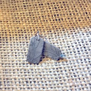 Oxidized silver earrings with leaf design.